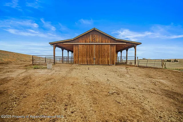 a backyard of a house with a yard and outdoor seating