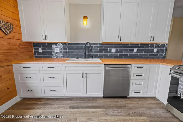 a view of a bathroom with a sink and wooden floor