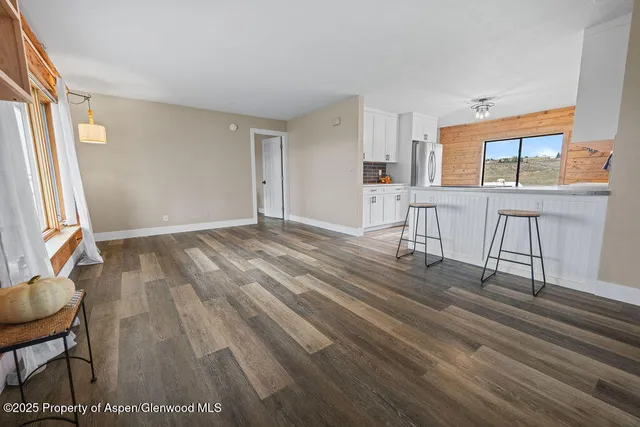 a kitchen with stainless steel appliances granite countertop a refrigerator and a stove