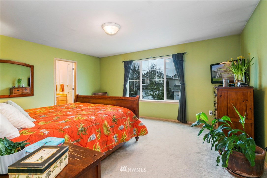 19010 4th Avenue Southeast Bothell, WA 98012 - Photo 11 of 20 a blue bed sitting in a bedroom next to a window