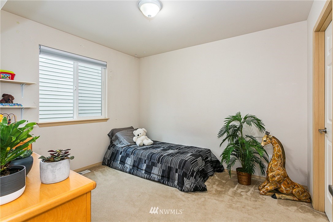 19010 4th Avenue Southeast Bothell, WA 98012 - Photo 12 of 20 a bed sitting in a bedroom next to a window