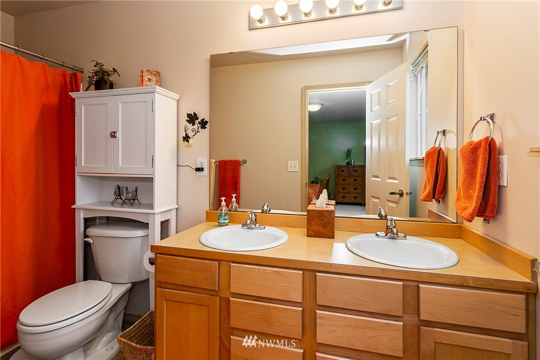 19010 4th Avenue Southeast Bothell, WA 98012 - Photo 15 of 20 a bathroom with a sink a toilet and mirror