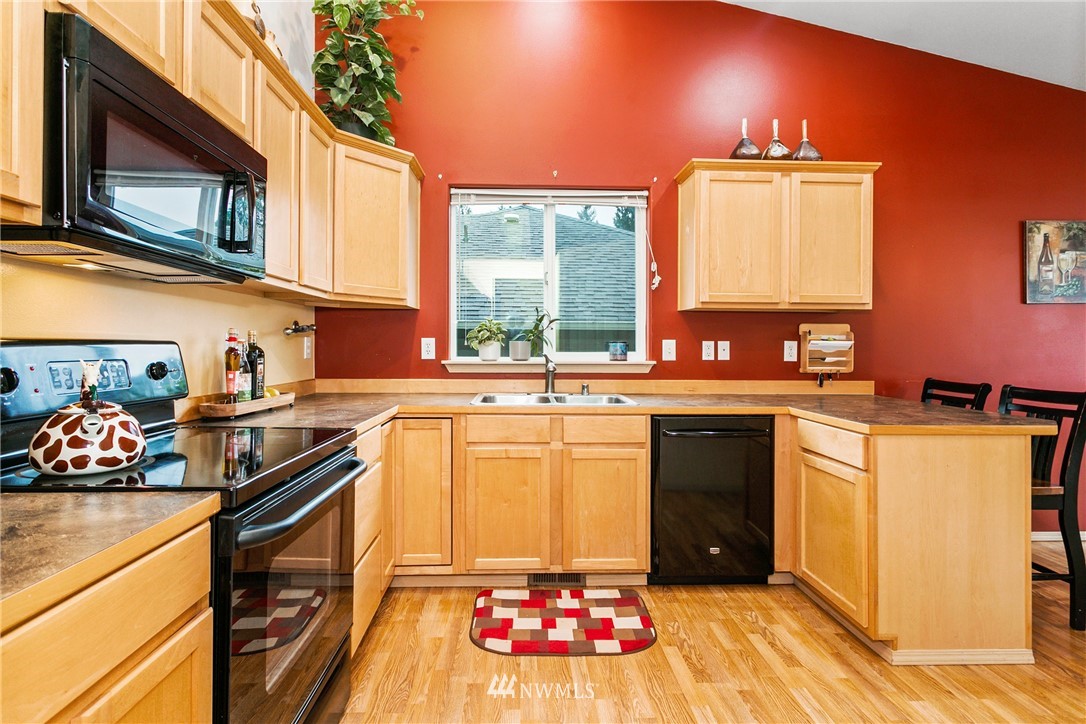 19010 4th Avenue Southeast Bothell, WA 98012 - Photo 7 of 20 a kitchen with a stove a sink and a microwave