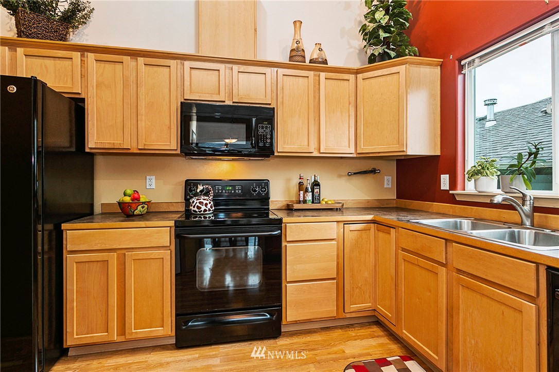 19010 4th Avenue Southeast Bothell, WA 98012 - Photo 8 of 20 a kitchen with stainless steel appliances granite countertop a stove a sink and a refrigerator