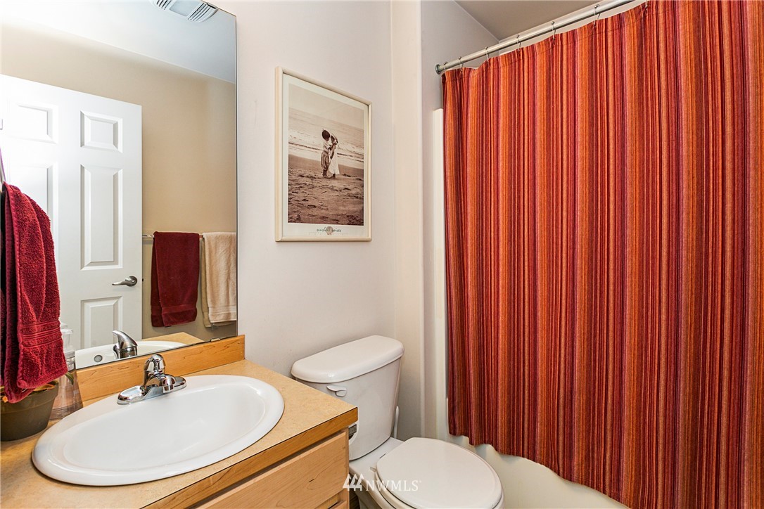 19010 4th Avenue Southeast Bothell, WA 98012 - Photo 10 of 20 a bathroom with a toilet a sink and a mirror