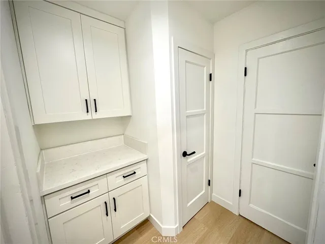 a view of a closet with wooden floor