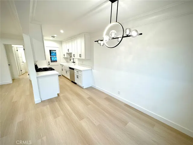 a kitchen with a sink cabinets and window