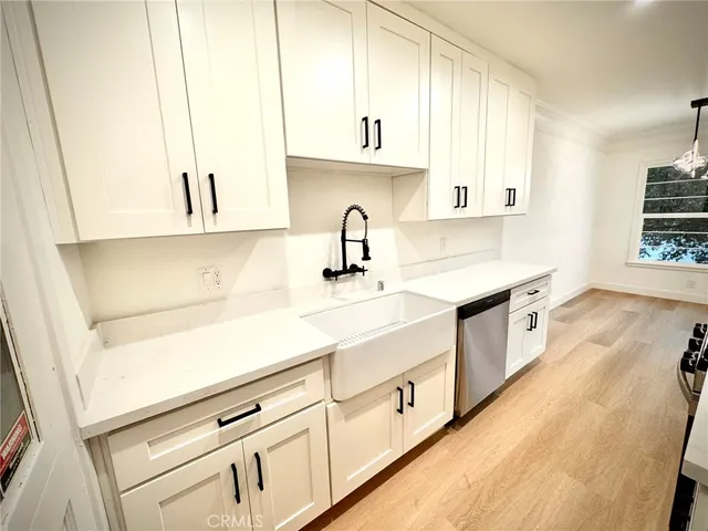 a kitchen with granite countertop white cabinets and white appliances