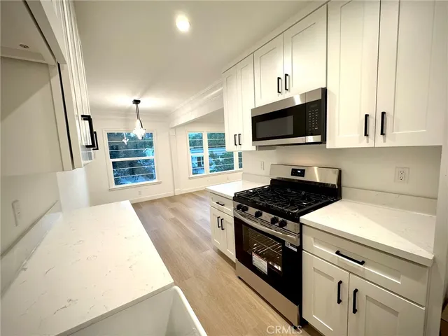 a kitchen with a stove and a microwave