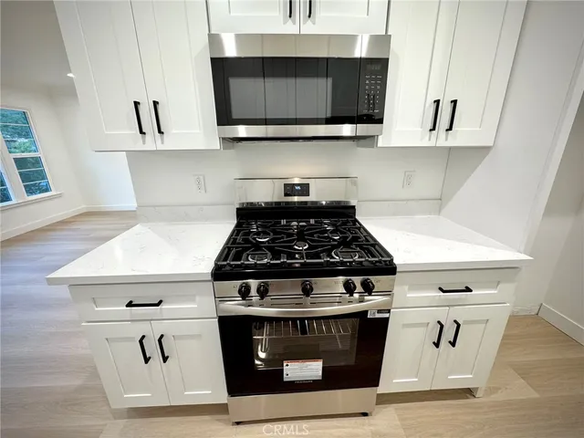 a stove top oven sitting inside of a kitchen