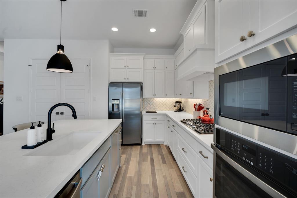 2221 Meridian Place Midlothian, TX 76065 - Photo 17 of 39 a kitchen with stainless steel appliances a sink stove and refrigerator
