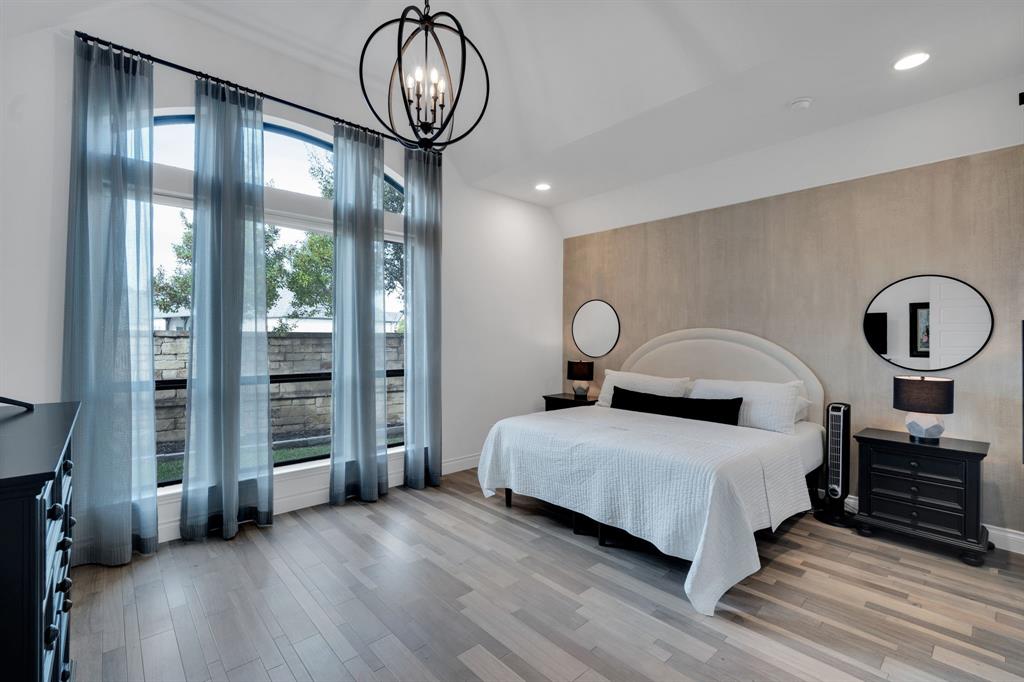 2221 Meridian Place Midlothian, TX 76065 - Photo 18 of 39 a bedroom with a bed a chandelier and balcony