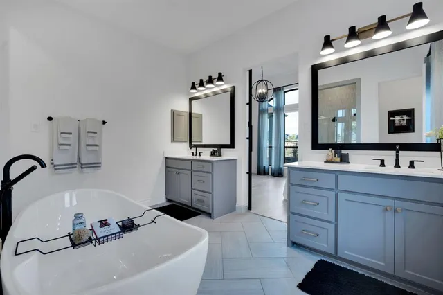 a bathroom with a tub sink and mirror