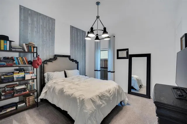 a bedroom with bed and a window