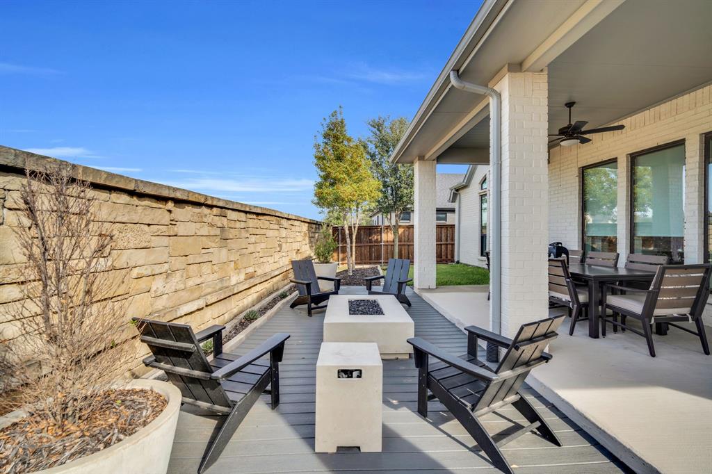 2221 Meridian Place Midlothian, TX 76065 - Photo 30 of 39 a view of a patio with table and chairs with wooden floor and fence