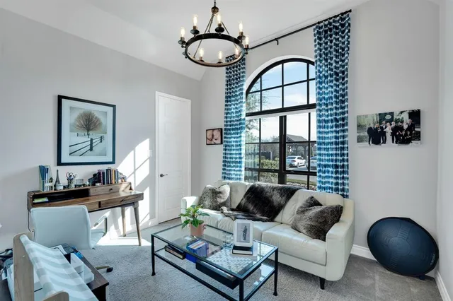a living room with furniture and a chandelier