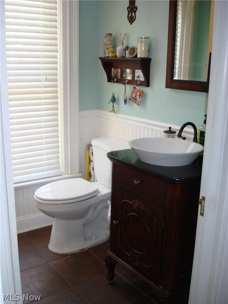 919 Richmond Road Cleveland, OH 44124 - Photo 23 of 35 Beautiful updated bathroom with a vintage style sink basin and cabinet, beadboarding, and a jetted Jacuzzi style tub and shower! Next to the master!