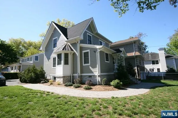 a front view of a house with a yard and porch