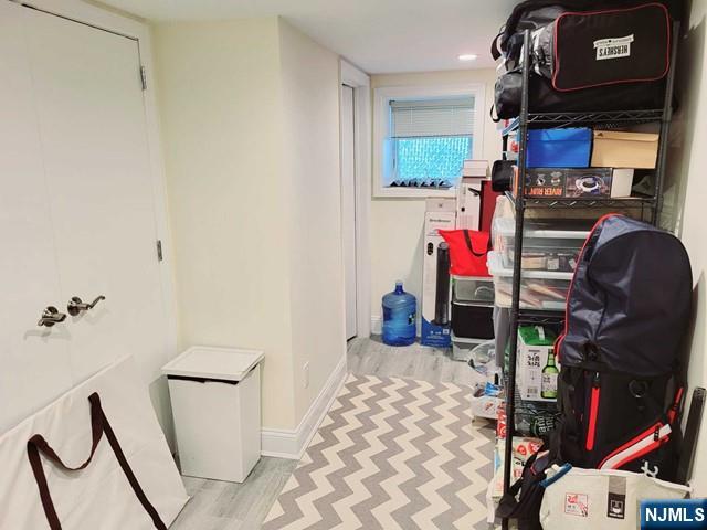 296 County Road, Unit 1 Tenafly, NJ 07670 - Photo 14 of 16 a bedroom with a bed and cabinets