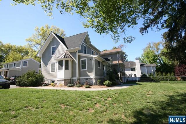 296 County Road, Unit 1 Tenafly, NJ 07670 - Photo 3 of 16 a front view of a house with a yard porch and tree