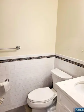 a white toilet sitting next to a shower