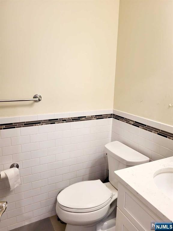 296 County Road, Unit 1 Tenafly, NJ 07670 - Photo 9 of 16 a white toilet sitting next to a shower