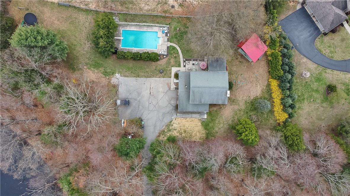 an aerial view of residential house with outdoor space and trees