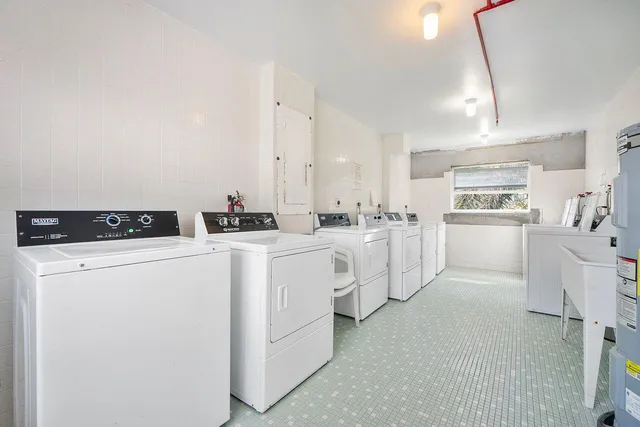 a utility room with cabinets washer and dryer