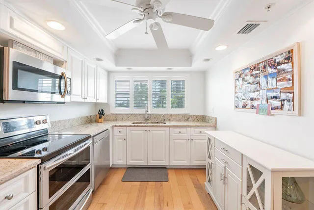 a kitchen with stainless steel appliances granite countertop a stove and a sink