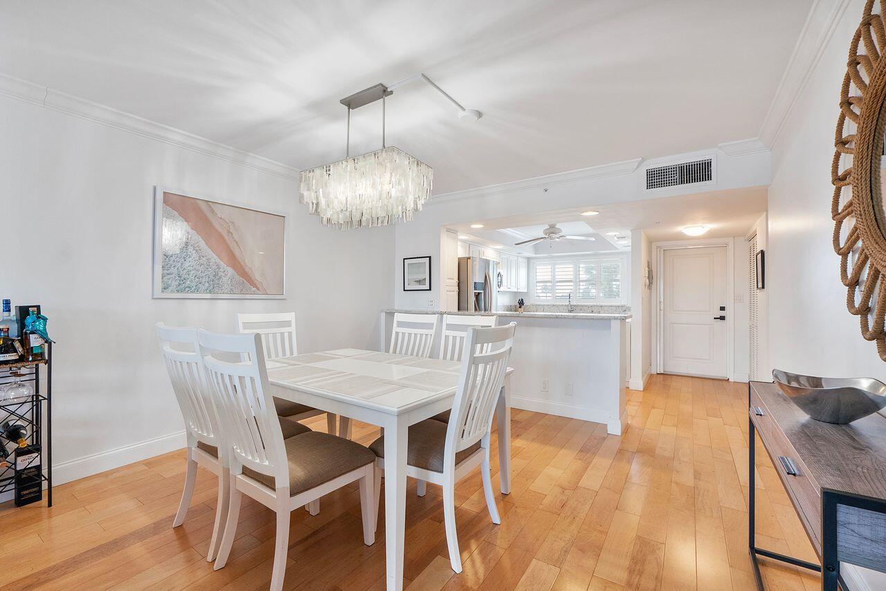 3310 South Ocean Boulevard, Unit 231D Highland Beach, FL 33487 - Photo 7 of 31 a view of a dining room with furniture and wooden floor