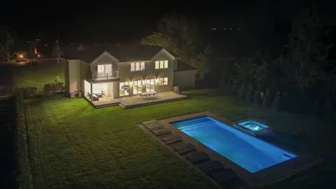 a view of a chairs in back yard of the house