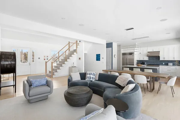 a living room with furniture and view of kitchen
