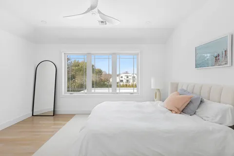 a bedroom with a large bed and a large window