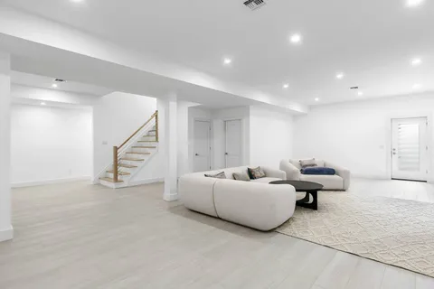 a living room with furniture and stairs
