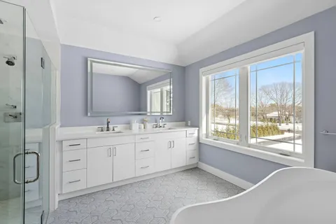 a bathroom with a granite countertop sink mirror and a bathtub