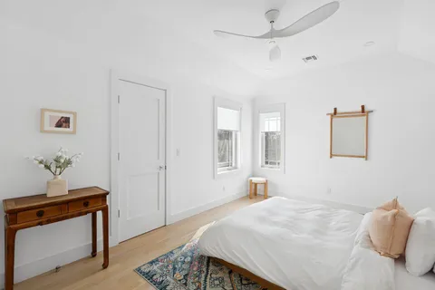 a bedroom with a bed and a potted plant