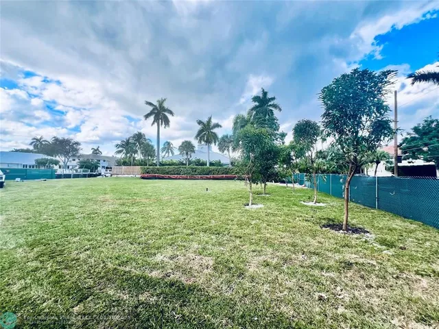 a swimming pool with lots of tress in the background