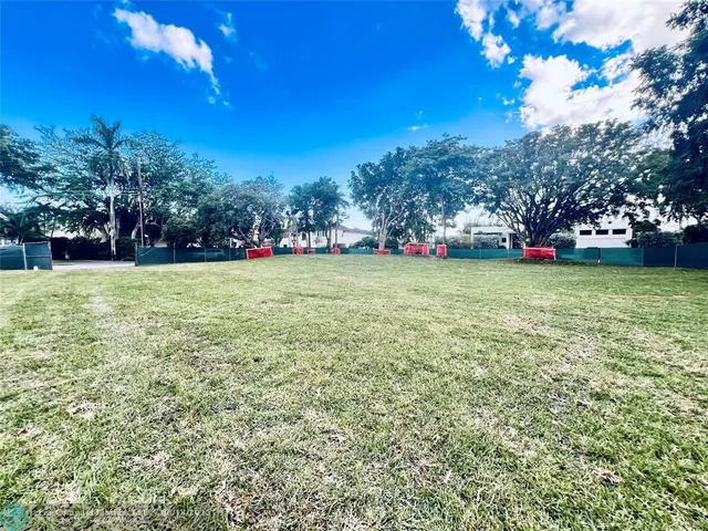 a view of a field of grass and trees