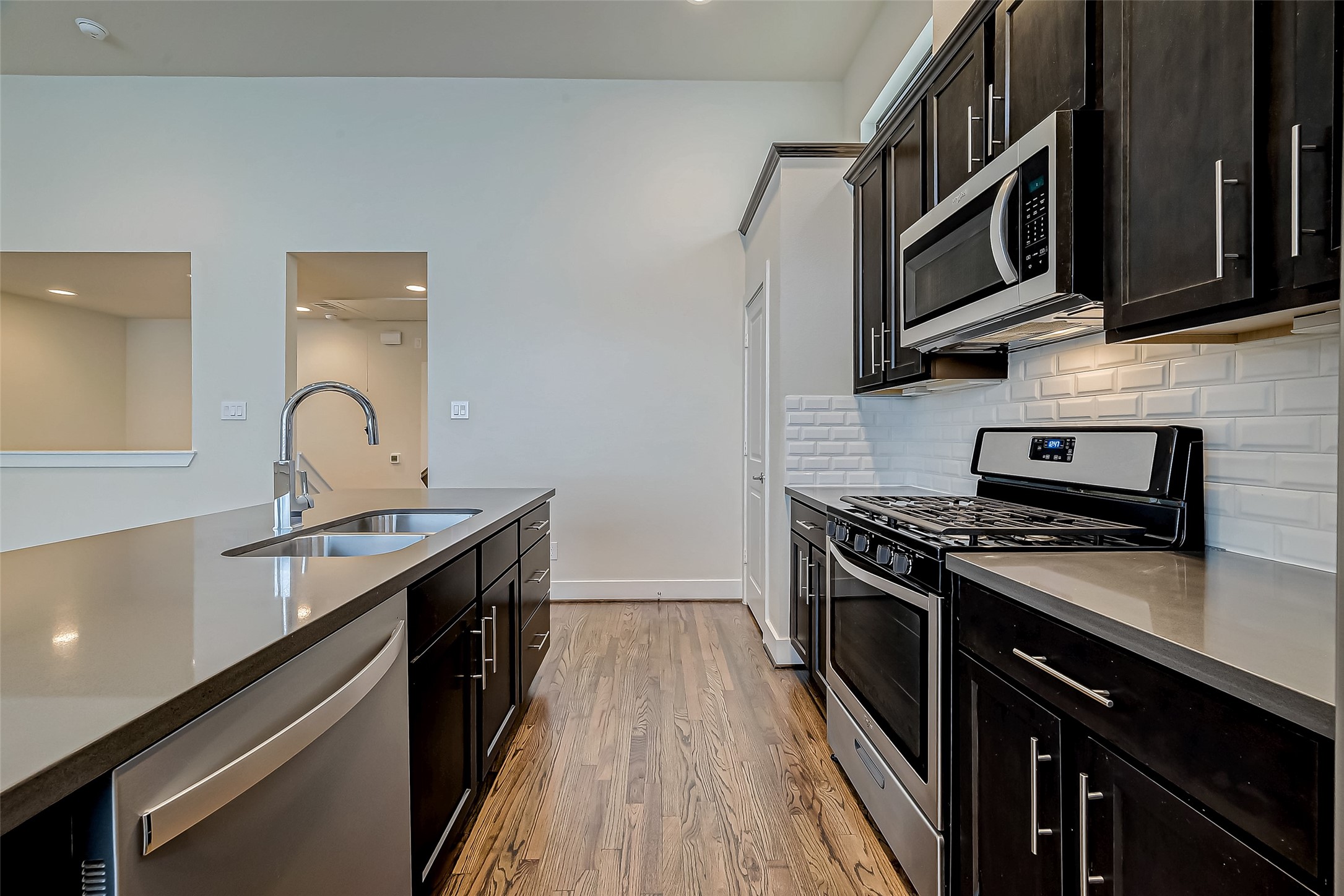 4025 Tulane Street Houston, TX 77018 - Photo 12 of 43 a kitchen with stainless steel appliances granite countertop a stove and a sink