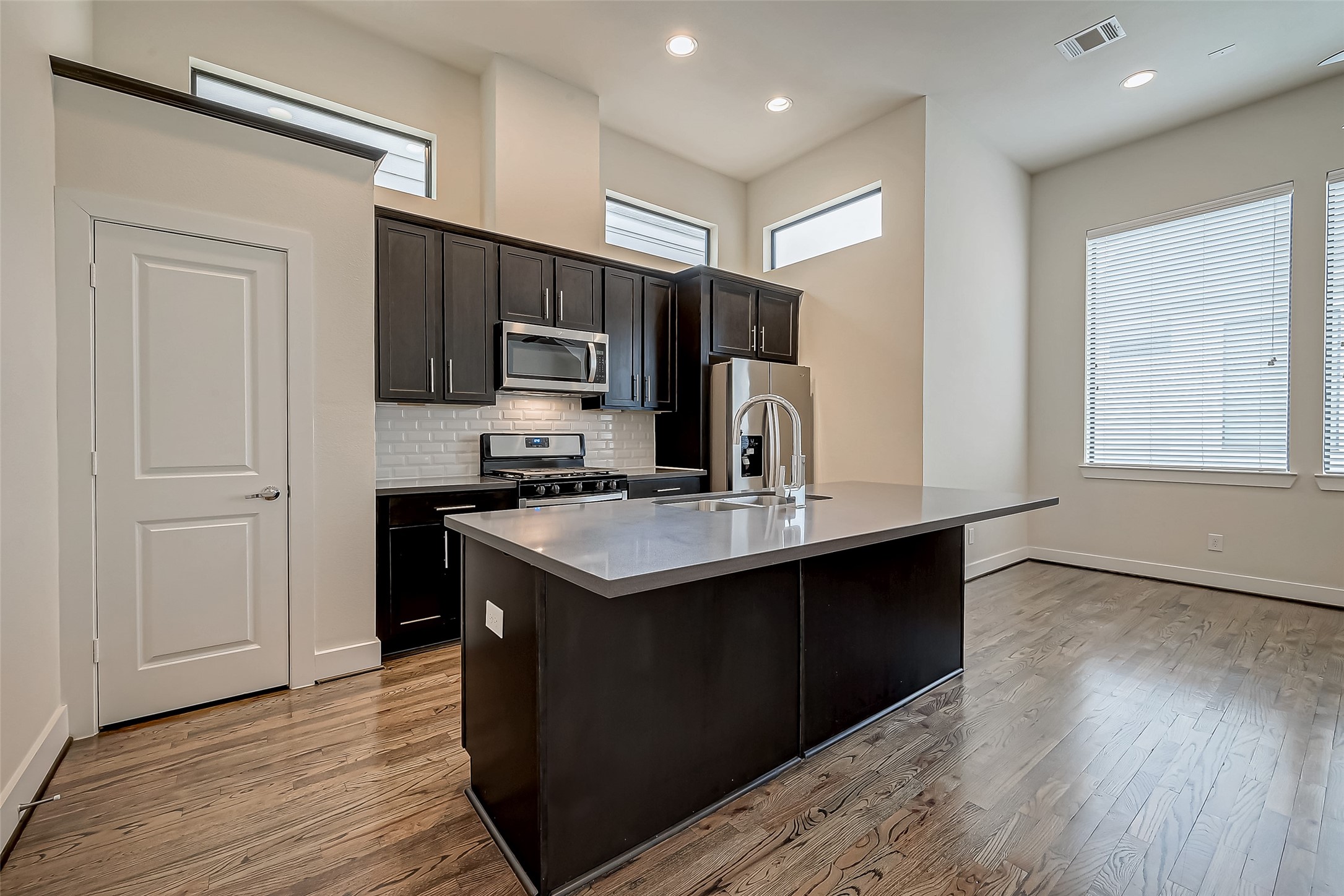 4025 Tulane Street Houston, TX 77018 - Photo 15 of 43 a kitchen with stainless steel appliances granite countertop a sink stove and refrigerator