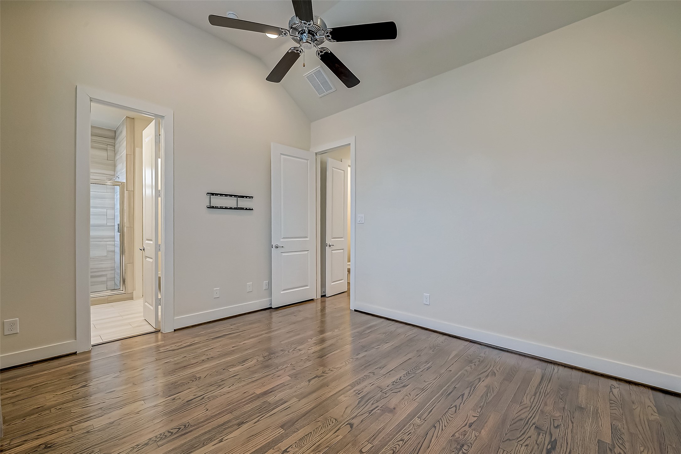 4025 Tulane Street Houston, TX 77018 - Photo 18 of 43 an empty room with wooden floor ceiling fan and windows