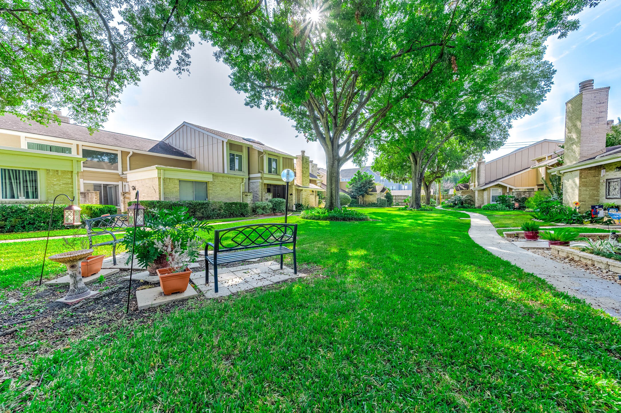 11609 Village Pl Drive Houston, TX 77077 - Photo 30 of 34 a front view of a house with a garden and outdoor seating