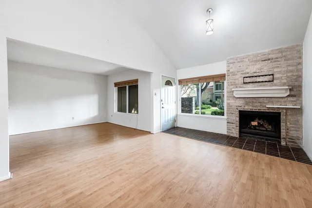 wooden floor fireplace and natural light in room