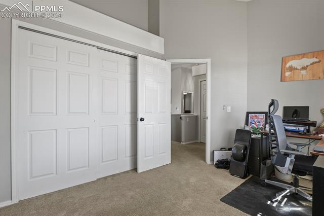8036 Ferguson Road Peyton, CO 80831 - Photo 17 of 29 Carpeted office space featuring a high ceiling