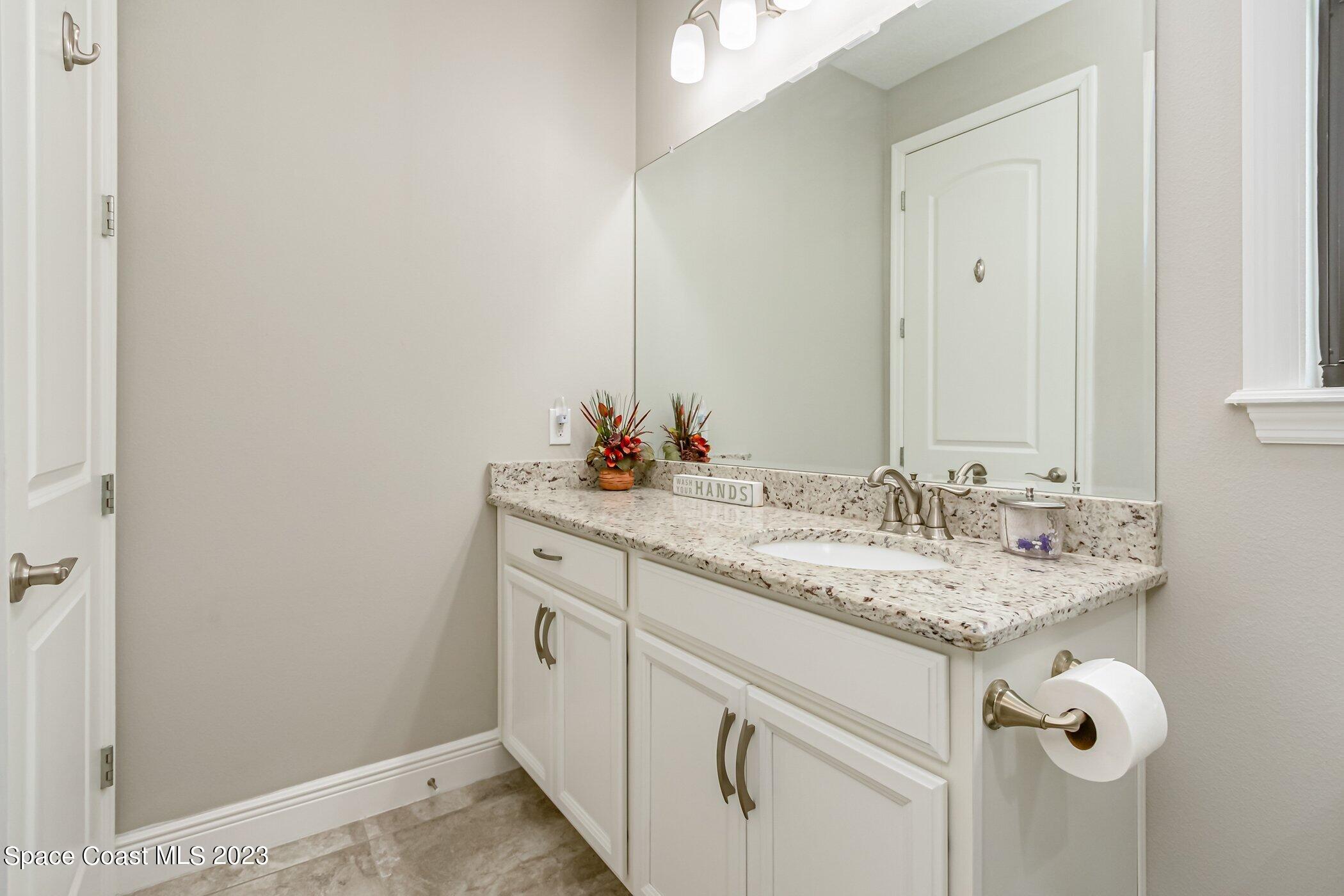 7729 Kerrington Drive Melbourne, FL 32940 - Photo 16 of 61 a bathroom with a sink and a mirror