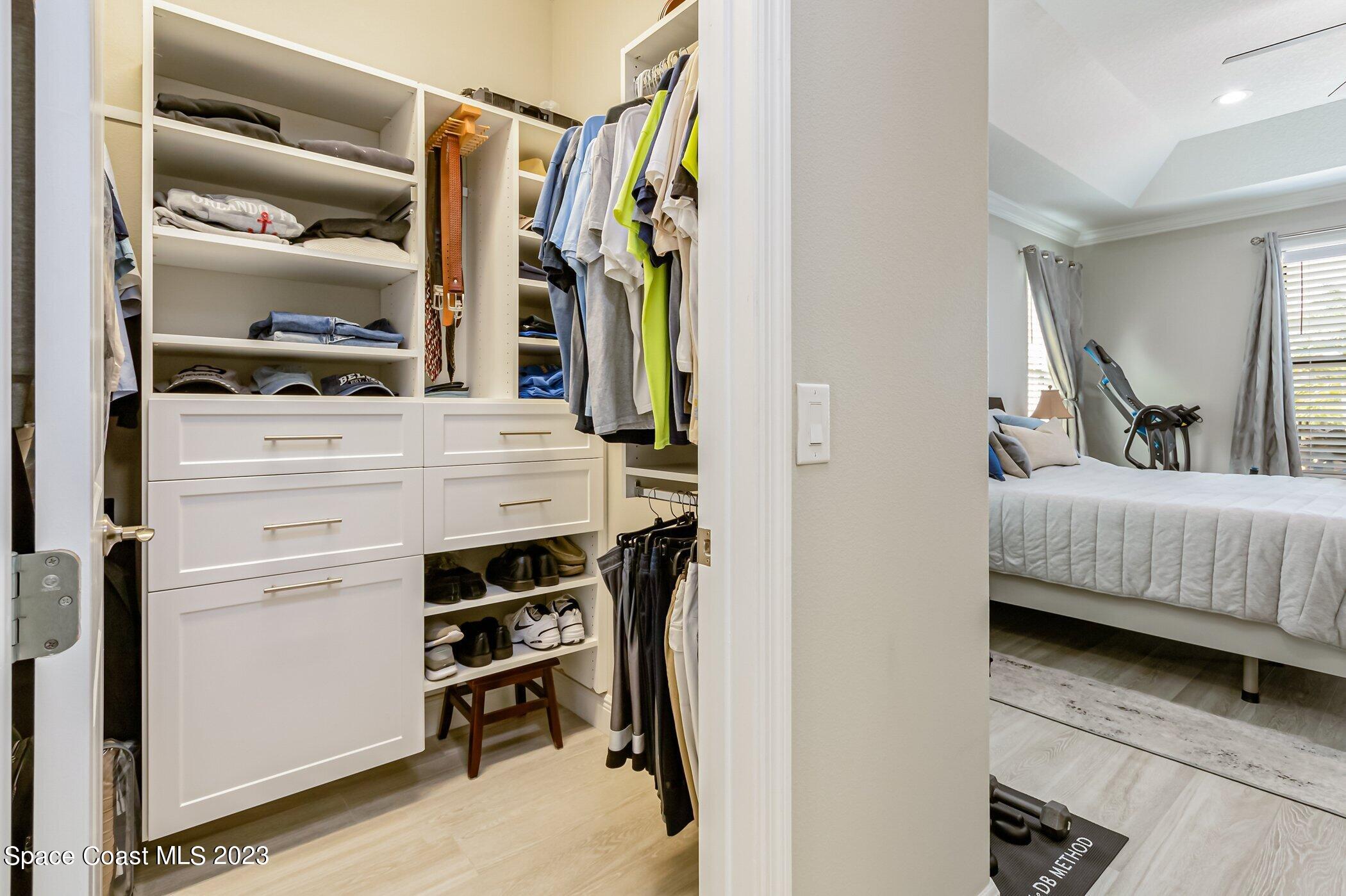7729 Kerrington Drive Melbourne, FL 32940 - Photo 23 of 61 a view of walk in closet with clothes and shoes