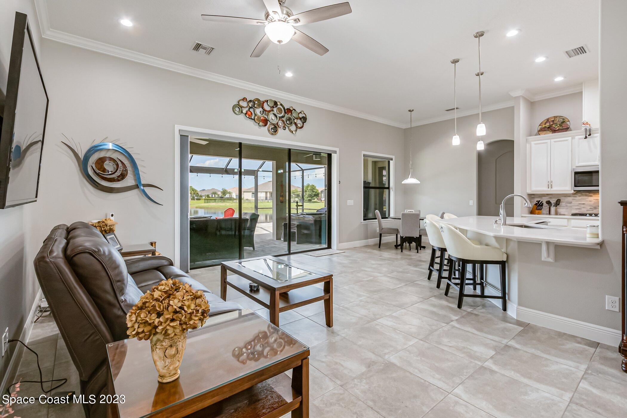 7729 Kerrington Drive Melbourne, FL 32940 - Photo 29 of 61 a living room with furniture and a large window