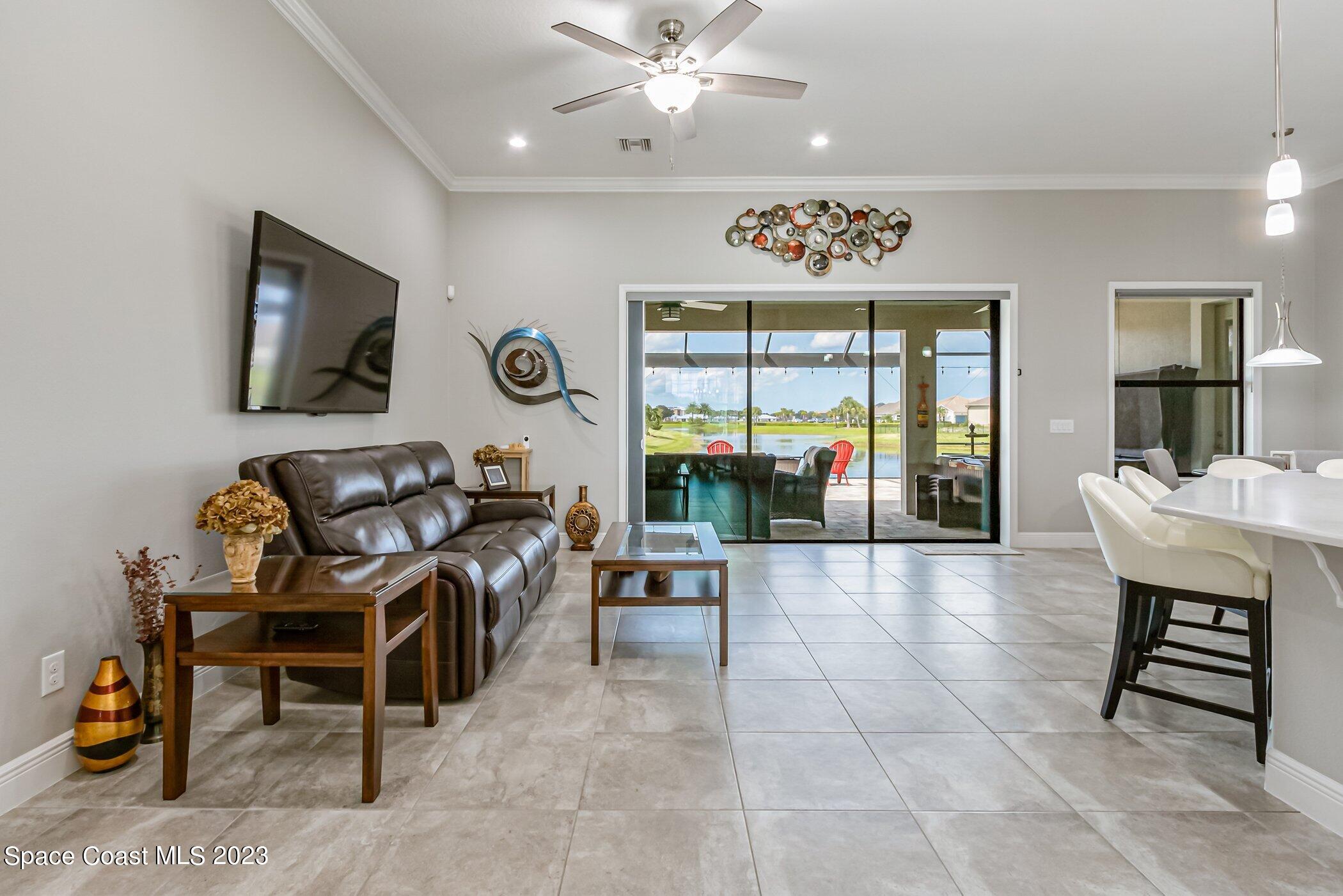 7729 Kerrington Drive Melbourne, FL 32940 - Photo 30 of 61 a lobby with furniture and floor to ceiling window