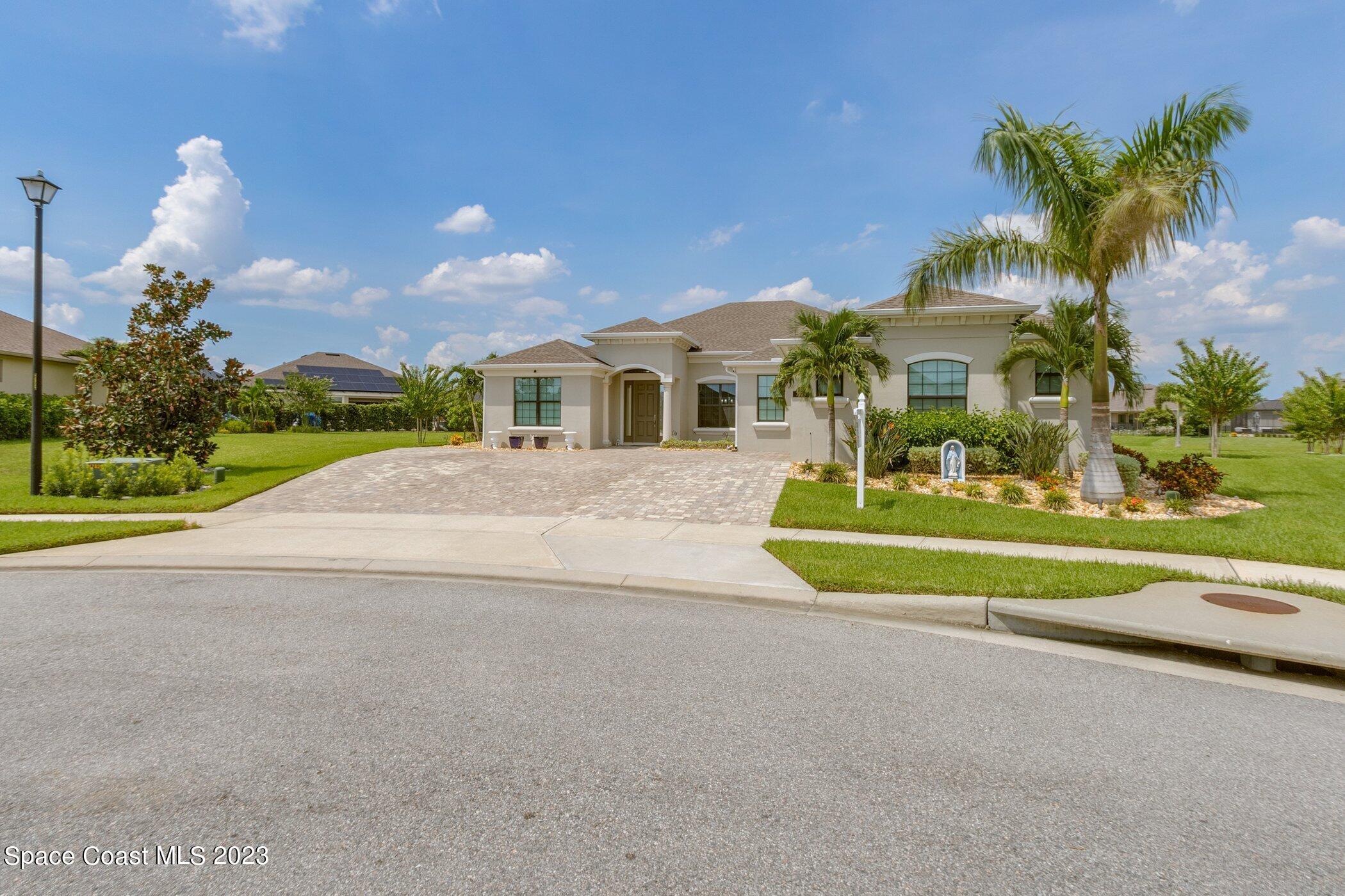 7729 Kerrington Drive Melbourne, FL 32940 - Photo 3 of 61 a view of house with a yard and potted plants