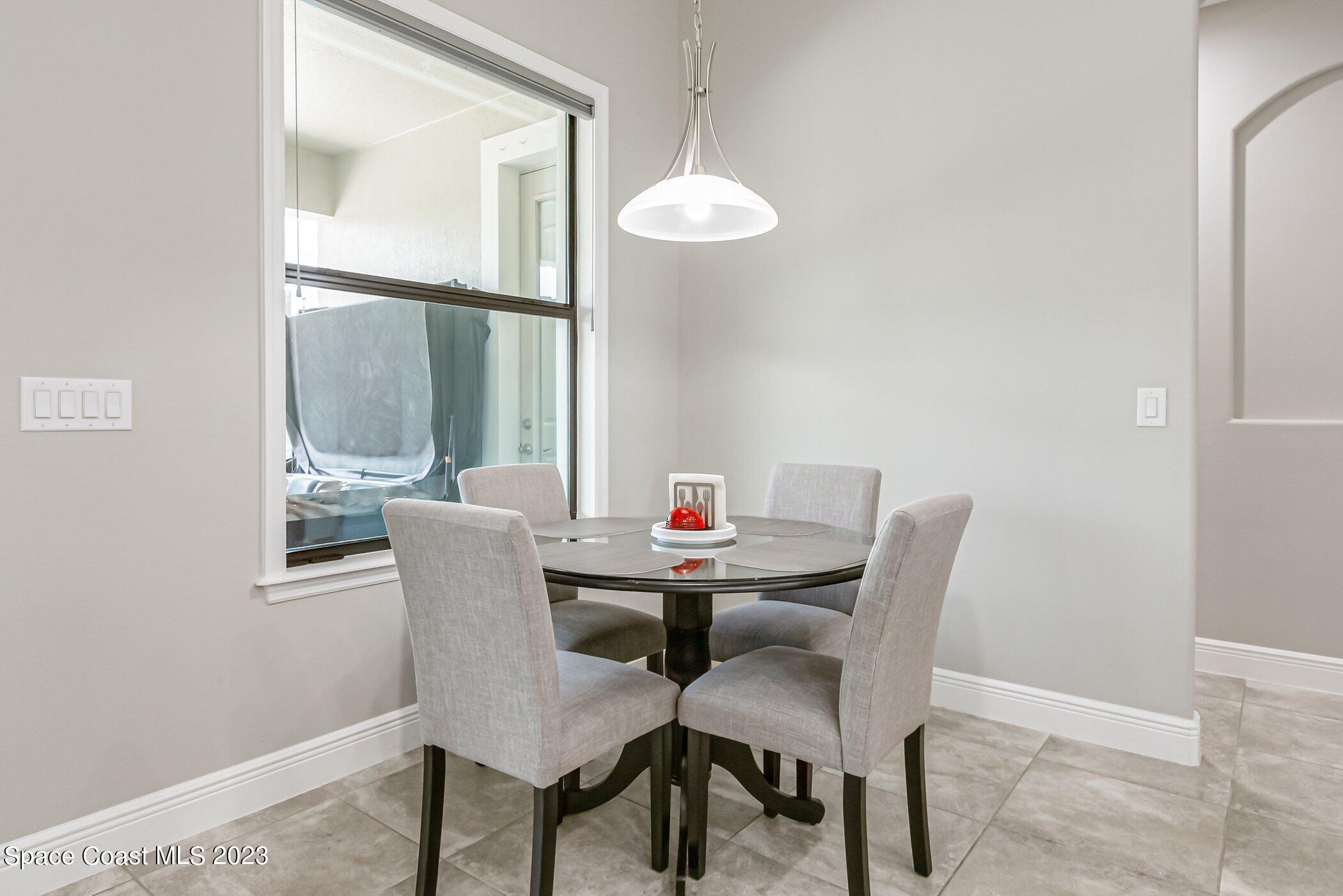 7729 Kerrington Drive Melbourne, FL 32940 - Photo 33 of 61 a view of a dining room with furniture and a window